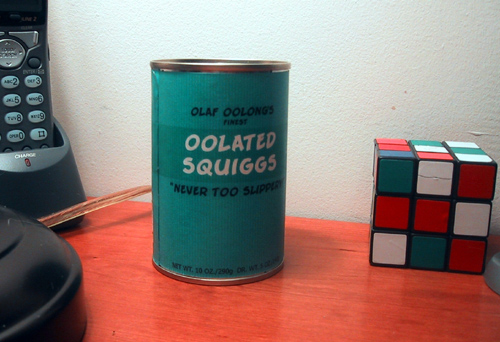 can of oolated squiggs (front) and Rubik's cube